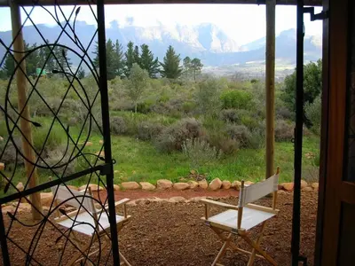 a room with a chair and a view of a mountain at Akkedis at Artemis in Franschhoek