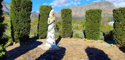 a statue in the middle of a forest of trees at Akkedis at Artemis in Franschhoek