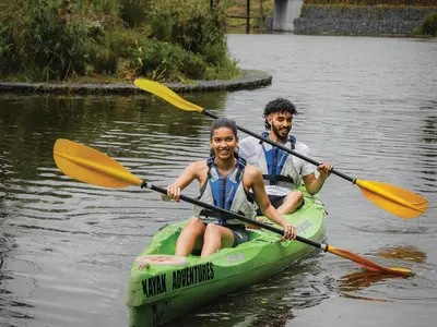 a man and a woman in a kayak on the water at Century City Hotel Bridgewater in Cape Town