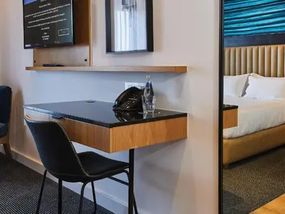 a bar in a hotel room with a bed at Century City Hotel Bridgewater in Cape Town