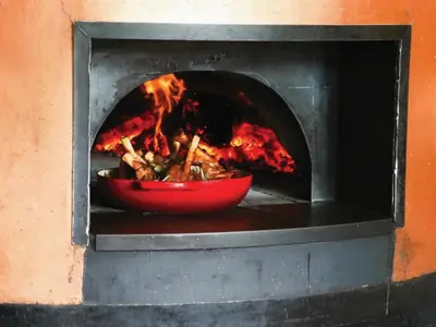 a fire oven with a bowl of food in it at Century City Hotel Bridgewater in Cape Town