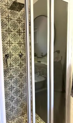 a bathroom with a shower and a sink at Open Room Comfort in Cape Town