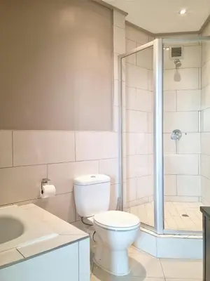 a bathroom with a toilet and a shower and a sink at Manhattan by Smart City Stays in Cape Town