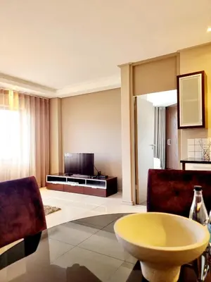 a living room with a couch and a table at Manhattan by Smart City Stays in Cape Town