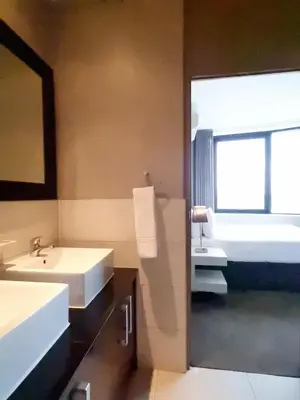 a bathroom with two sinks and a large window at Manhattan by Smart City Stays in Cape Town