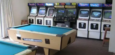 a pool table in front of a row of slot machines at Hermanus Beach Club - St Tides House 19 in Hermanus