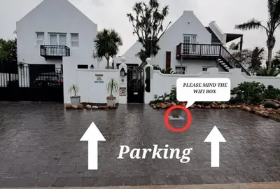 a house with a parking sign in front of it at Cape Dutch Flair in Durbanville