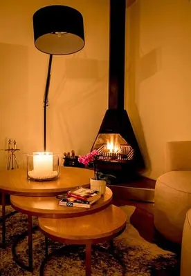 a living room with a table and a fireplace at Macaron Boutique Guest House in Franschhoek