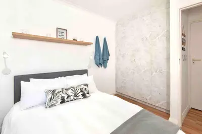 a bedroom with a white bed with a zebra pillow at Luxury @ the Ocean in Hermanus