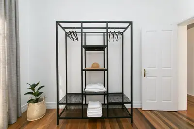 a black shelf in a room with a door at La Maison On Main Self-Catering Villa in Paarl