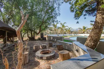 a courtyard with a fire pit and trees at the MANOR house by Kana Guest Farm - Ideal for groups in Stellenbosch