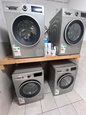 two washing machines and a washer and dryer on a shelf at the MANOR house by Kana Guest Farm - Ideal for groups in Stellenbosch