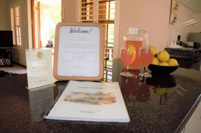 a counter top with a menu and a bottle of juice at Smith Cottage in Franschhoek