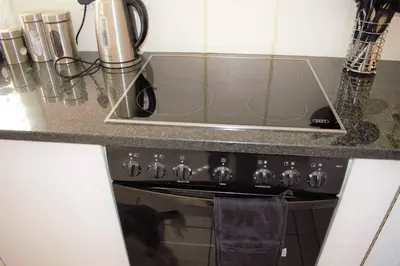 a kitchen counter with a sink and a stove at Smith Cottage in Franschhoek