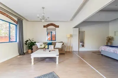a living room with a couch and a coffee table at Sunset Beach holiday accommodation in Cape Town