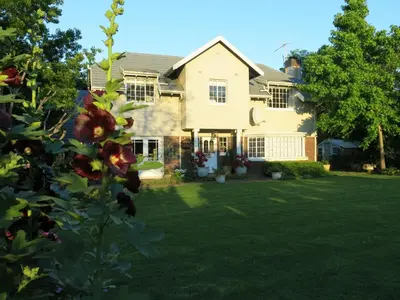 a house with a yard with a flower at Featherbed in Somerset West