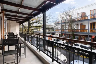 a balcony with a table and a view of a street at Avemore Jan Cats No 5 full backup power in Stellenbosch