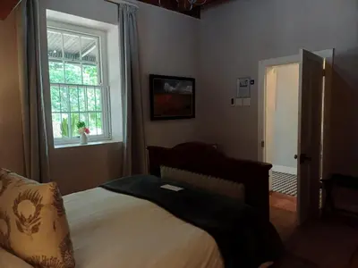a bedroom with a bed and a window at Diamant Estate in Paarl