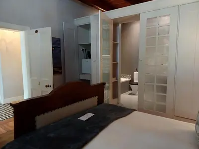 a bedroom with a bed and a bathroom with a toilet at Diamant Estate in Paarl