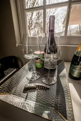 two wine glasses sitting on a table next to a window at Corner House Residence in Franschhoek