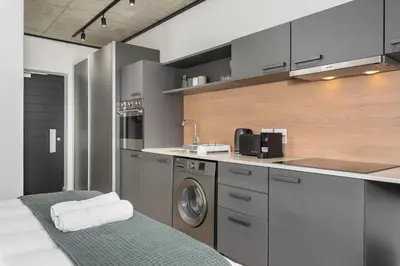 a kitchen with a washing machine and a washer at Bridgewater One Apartments in Cape Town