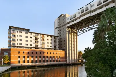 a bridge over a river next to a building at Knightsbridge 407 by Host Agents in Cape Town