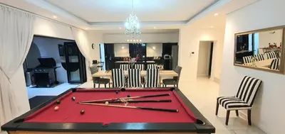 a red pool table in a room with chairs at Villa Parisienne Modern Guest house in Cape Town