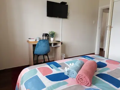 a bedroom with a bed with two towels on it at Proleefic House on Florence in Bellville