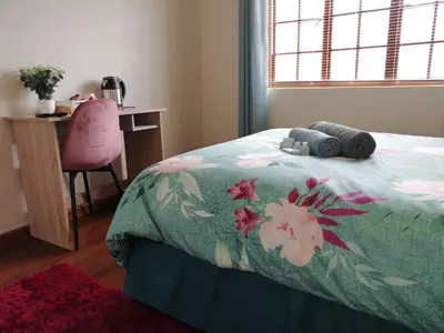 a bedroom with a bed and a desk and a chair at Proleefic House on Florence in Bellville