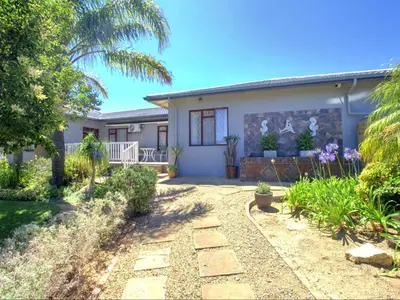 a house with a garden in front of it at Glennies Guesthouse in Somerset West