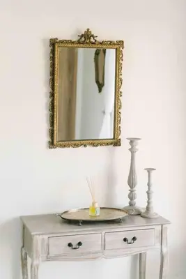 a mirror on top of a dresser in a room at Bright and airy Parisian Gem close to the beach in Cape Town