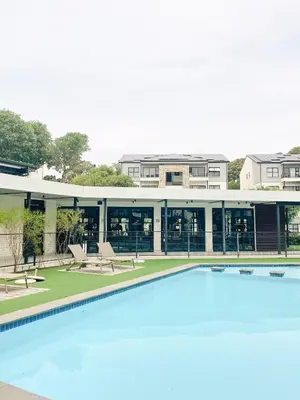 a large swimming pool in front of a building at Bright and airy Parisian Gem close to the beach in Cape Town