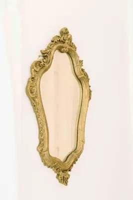 an ornate gold mirror on a white background at Bright and airy Parisian Gem close to the beach in Cape Town