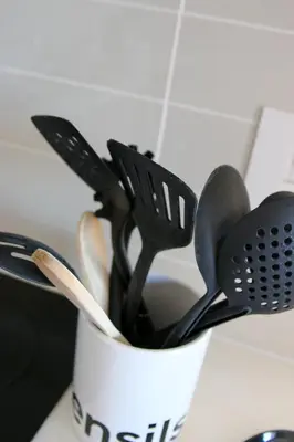 a cup filled with lots of kitchen utensils at The Jade Somerset West in Cape Town