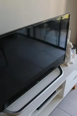 a flat screen tv on a white tv stand at The Jade Somerset West in Cape Town