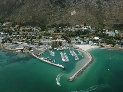 an aerial view of a harbor with boats in the water at The Anchor, Luxury living for 2 with sea view and Jacuzzi in Gordonʼs Bay