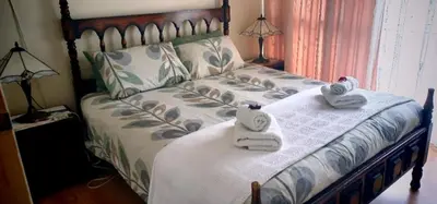 a bedroom with a bed with towels on it at St Tropez 301 in Strand