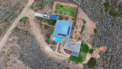 an overhead view of a house with a blue roof at Exquisite chalet on private nature reserve in Wolseley