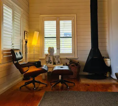 a living room with two chairs and a stove at Exquisite chalet on private nature reserve in Wolseley