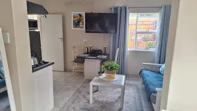 a living room with a couch and a table at Senelle accomodation in Hermanus