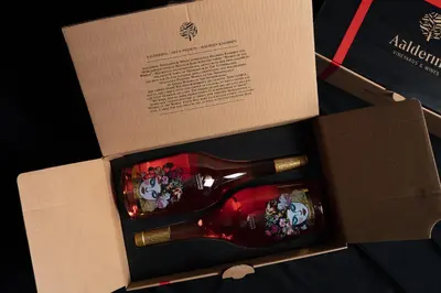 a bottle of wine in a cardboard box at Aaldering Luxury Lodges in Stellenbosch