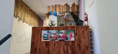 a wooden wall with a picture of a fire truck on it at Sunset beach backpackers in Bloubergstrand