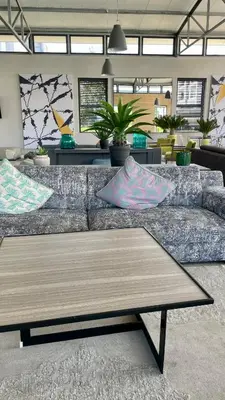 a living room with a couch with pillows on it at 417 The Sandown in Cape Town