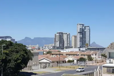 a city with tall buildings and a street with a car at Complete self-catering apartment close to the beach in Cape Town