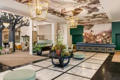a lobby with green walls and a ceiling with plants at Lord Charles Hotel, Somerset West, a Tribute Portfolio Hotel in Somerset West
