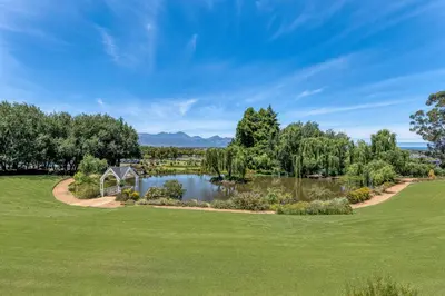 an aerial view of a golf course with a pond at Lord Charles Hotel, Somerset West, a Tribute Portfolio Hotel in Somerset West