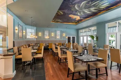 a dining room with tables and chairs and a painting on the ceiling at Lord Charles Hotel, Somerset West, a Tribute Portfolio Hotel in Somerset West