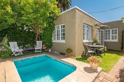 a small swimming pool in front of a house at Suburban bliss with Wifi and plunge pool in Cape Town