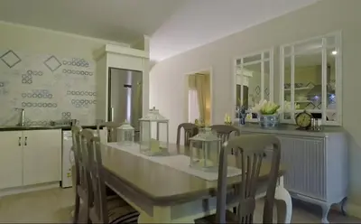 a kitchen with a table and chairs and a counter at Century City Mayfair Luxury Apartments in Cape Town