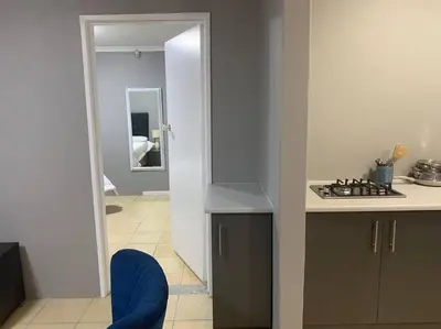 a kitchen with a stove and a counter top at SpaciousNetflix#Wifi#Parking#CentralWinefarms#Mall in Cape Town